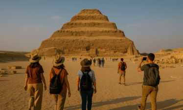 Step Pyramid of Saqqara with visitors exploring the ancient pyramid complex in Egypt