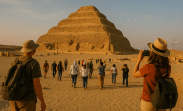 Step Pyramid of Saqqara with visitors exploring the ancient pyramid complex in Egypt