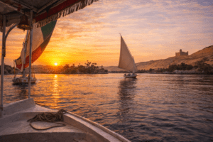 Felucca sailing at sunset on the Nile River in Aswan Egypt