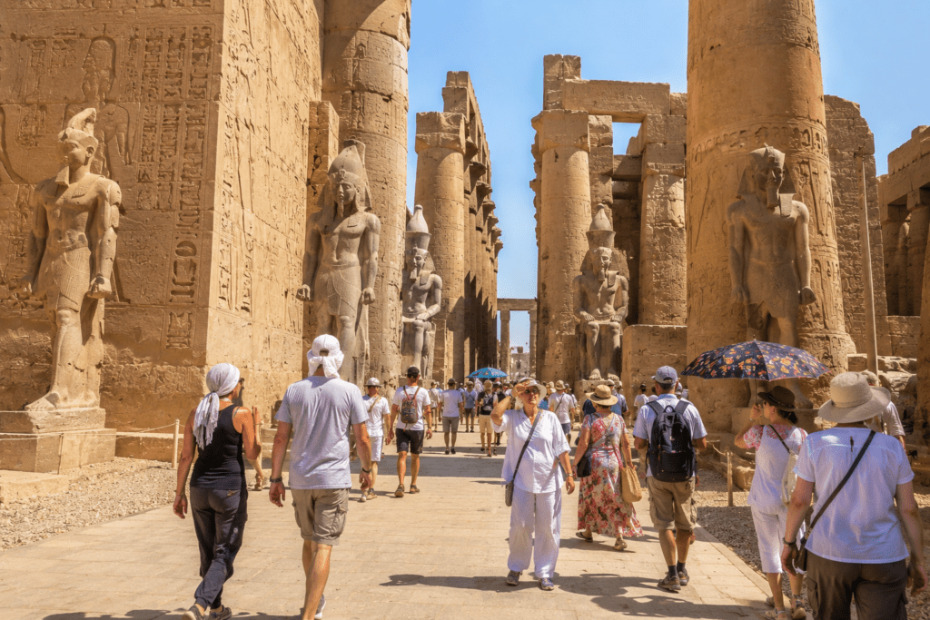 Visitors exploring Egyptian temples in Upper Egypt heat