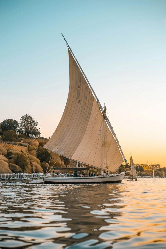 A traditional felucca sails along the Nile near Aswan