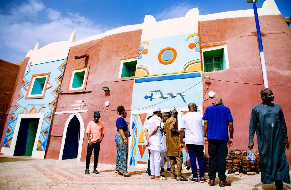 Vibrant traditional architecture with diverse group of people outdoors.