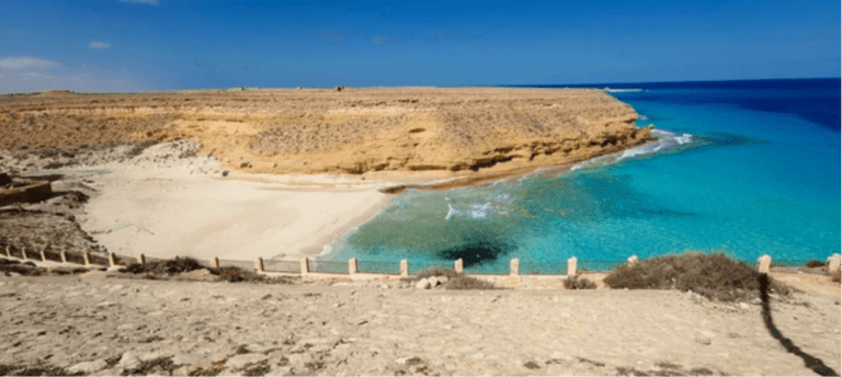 Turquoise Mediterranean water and white sand beach in Marsa Matrouh, Egypt.