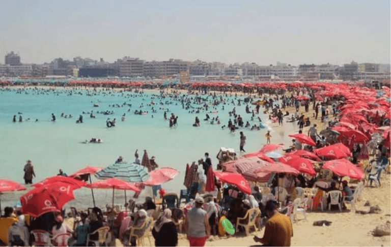 Egyptian families enjoying a summer vacation on the turquoise Mediterranean beaches of Marsa Matrouh.