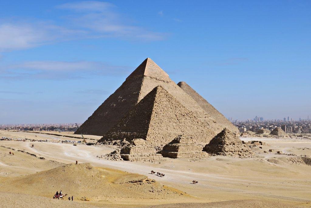 Stunning daytime view of the Great Pyramids of Giza with clear blue skies.