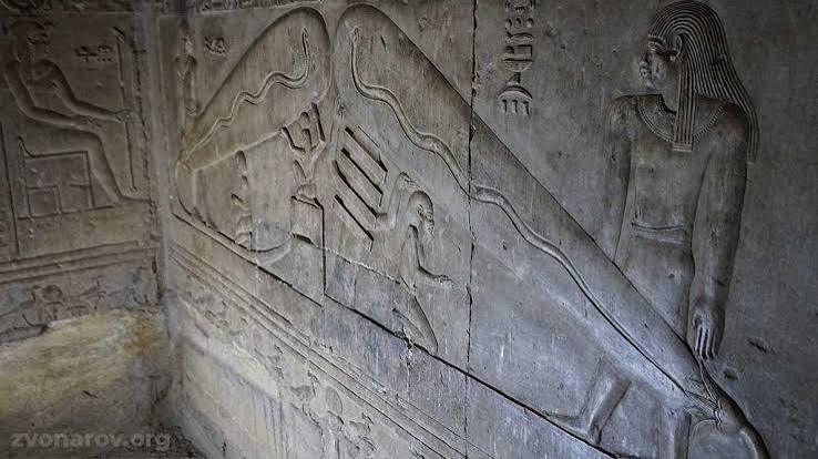 Harsomtus serpent and lotus relief in a crypt beneath Dendera Temple.