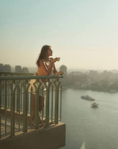 Traveler enjoying a Nile view from a balcony