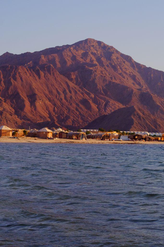 Breathtaking view of Nuweiba's coastal landscape with mountains and sea at sunset.